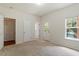 Bedroom showcasing neutral carpet, a closet, and a window for natural light at 615 Carlton Commons Ln, Cary, NC 27519