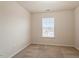 Cozy bedroom with neutral carpeting and a window providing natural light at 615 Carlton Commons Ln, Cary, NC 27519