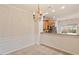 Open dining room with stylish chandelier and half wall overlooking the kitchen, perfect for entertaining and Gathering meals at 615 Carlton Commons Ln, Cary, NC 27519