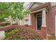 Inviting entryway featuring brick accents, neat landscaping, and a welcoming front door at 615 Carlton Commons Ln, Cary, NC 27519