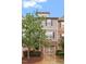 Townhome exterior shows detailed brickwork, stylish siding, well-kept landscaping, and convenient garage access at 615 Carlton Commons Ln, Cary, NC 27519