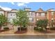 Charming townhome exterior featuring diverse architectural styles, manicured landscaping, and inviting curb appeal at 615 Carlton Commons Ln, Cary, NC 27519