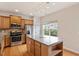 Modern kitchen with stainless steel appliances, a center island with storage, and hardwood floors, perfect for cooking at 615 Carlton Commons Ln, Cary, NC 27519