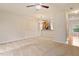 Open living room with view into kitchen; features neutral carpet and chandelier at 615 Carlton Commons Ln, Cary, NC 27519