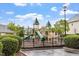 Charming community playground featuring a slide and climbing structure nestled among lush greenery and well-maintained grounds at 615 Carlton Commons Ln, Cary, NC 27519