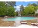 Enjoy the beautiful community pool, a refreshing oasis nestled among mature trees, offering residents a serene and relaxing experience at 615 Carlton Commons Ln, Cary, NC 27519