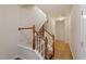 Elegant staircase featuring hardwood floors, white railings, and carpeted steps leading to the upper level at 615 Carlton Commons Ln, Cary, NC 27519