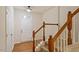 Bright entryway featuring a wooden staircase, hardwood floors, and a stylish front door at 615 Carlton Commons Ln, Cary, NC 27519