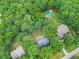 Aerial view of home with a pool and lush trees, illustrating the beautiful surroundings at 618 Durwood Dr, Raleigh, NC 27603