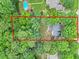 Overhead shot of home, nestled among a lush canopy of trees, promoting serenity and privacy at 618 Durwood Dr, Raleigh, NC 27603