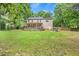 Beautiful home with a large backyard, lush green grass, and a spacious deck at 618 Durwood Dr, Raleigh, NC 27603
