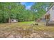 Large backyard with mature trees, a storage shed, and a firepit, perfect for outdoor enjoyment at 618 Durwood Dr, Raleigh, NC 27603