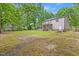 Expansive backyard featuring a deck, storage shed, and lush greenery, creating a private retreat at 618 Durwood Dr, Raleigh, NC 27603