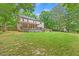 Spacious backyard with a large deck, perfect for entertaining, in a home surrounded by lush trees at 618 Durwood Dr, Raleigh, NC 27603