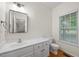 Bright bathroom with white vanity, mirror, and natural light at 618 Durwood Dr, Raleigh, NC 27603