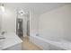 Bathroom with double sinks, a large tub, and a separate shower at 618 Durwood Dr, Raleigh, NC 27603
