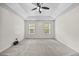 Large bedroom with neutral carpet, two windows, and a ceiling fan at 618 Durwood Dr, Raleigh, NC 27603