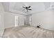 Spacious bedroom featuring neutral paint, carpet and tray ceiling with fan at 618 Durwood Dr, Raleigh, NC 27603