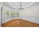 Spacious dining room featuring hardwood floors, chandelier, and large windows at 618 Durwood Dr, Raleigh, NC 27603