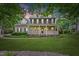 Charming two-story home featuring a welcoming front porch and well-maintained landscaping at 618 Durwood Dr, Raleigh, NC 27603