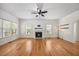 Bright and airy living room featuring a fireplace, ceiling fan, and hardwood floors at 618 Durwood Dr, Raleigh, NC 27603
