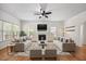 Bright and airy living room featuring a fireplace, ceiling fan, and hardwood floors at 618 Durwood Dr, Raleigh, NC 27603