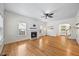 Sun-filled living room with hardwood floors, fireplace, and ceiling fan at 618 Durwood Dr, Raleigh, NC 27603