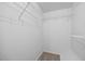 Walk-in closet with ample storage shelves and carpeted floor at 618 Durwood Dr, Raleigh, NC 27603