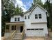 New two story home with an attached two car garage and a cozy front porch and stone steps at 701 Locust Ln, Raleigh, NC 27603