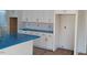 Kitchen featuring white cabinets with modern brass hardware, and blue protective coverings on the countertops at 701 Locust Ln, Raleigh, NC 27603