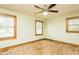 Bedroom with a ceiling fan, two windows, carpeted floor, and pale green walls at 7030 Stockard Rd, Snow Camp, NC 27349