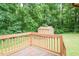 Wooden deck overlooking a wooded backyard with a storage shed at 7030 Stockard Rd, Snow Camp, NC 27349