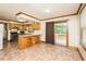 A spacious kitchen with a breakfast bar island, stainless steel appliances, and access to the outdoor deck at 7030 Stockard Rd, Snow Camp, NC 27349