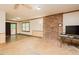 Spacious living room with brick fireplace and access to back deck, creating seamless indoor-outdoor living at 7030 Stockard Rd, Snow Camp, NC 27349