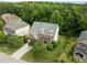 Aerial view of a single Gathering home with mature trees and lush landscaping in a desirable neighborhood at 7409 Chesley Ln, Durham, NC 27713