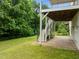 Covered backyard patio offers great space, perfect for entertaining guests with an entrance to a large lawn at 7409 Chesley Ln, Durham, NC 27713
