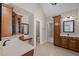 Spacious bathroom featuring dual vanities, wood cabinetry, and a separate toilet room at 7409 Chesley Ln, Durham, NC 27713