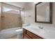 Bathroom with tub and shower combo, neutral tiling, and vanity at 7409 Chesley Ln, Durham, NC 27713