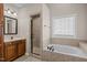 Bathroom featuring shower and tub and neutral tiling at 7409 Chesley Ln, Durham, NC 27713