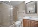 Bathroom features tiled walk-in shower, tile floor and a decorative mirror at 7409 Chesley Ln, Durham, NC 27713