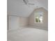 Bedroom with large window, neutral carpet, and vaulted ceiling at 7409 Chesley Ln, Durham, NC 27713