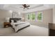 Comfortable bedroom with ample natural light, neutral walls, and a ceiling fan at 7409 Chesley Ln, Durham, NC 27713
