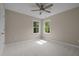 Bright bedroom with neutral carpeting and two windows at 7409 Chesley Ln, Durham, NC 27713