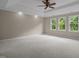 Large bedroom with neutral walls, crown molding, and large windows for natural light at 7409 Chesley Ln, Durham, NC 27713