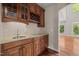 Charming butler's pantry with wood cabinets, wine rack, granite counters, and adjacent dining area at 7409 Chesley Ln, Durham, NC 27713