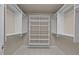 Walk-in closet with shelves and hanging rods for optimal storage at 7409 Chesley Ln, Durham, NC 27713