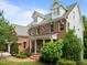 Beautiful brick home shows off a landscaped front yard with dormers, architectural details, and a welcoming porch at 7409 Chesley Ln, Durham, NC 27713