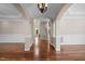 Elegant foyer featuring arched doorways, dark hardwood floors, wainscotting, and a decorative chandelier at 7409 Chesley Ln, Durham, NC 27713