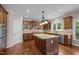 Open kitchen featuring granite countertops, stainless steel appliances, wood cabinets, and a kitchen island at 7409 Chesley Ln, Durham, NC 27713