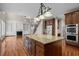 Spacious kitchen with large island, stainless appliances, and open view of the living space at 7409 Chesley Ln, Durham, NC 27713